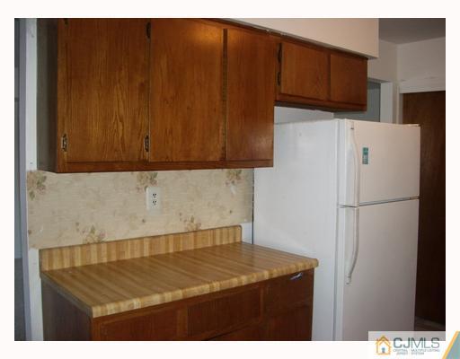 1537 Raspberry Court Edison, NJ 08817 - Photo 4 of 10 a kitchen with a refrigerator and a cabinets