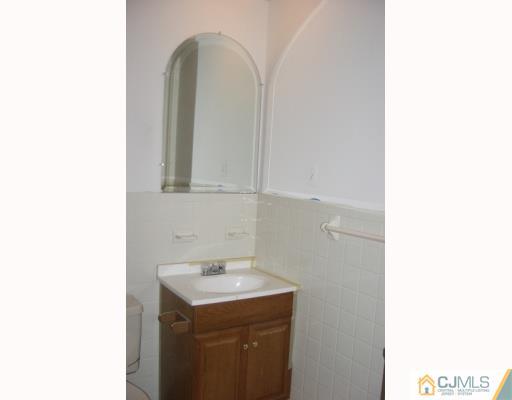 1537 Raspberry Court Edison, NJ 08817 - Photo 6 of 10 a bathroom with a sink and a mirror
