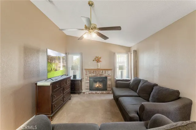 a living room with furniture a fireplace and a chandelier