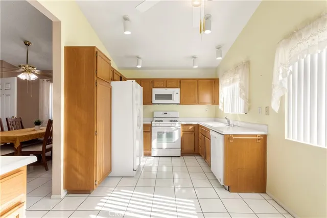 a kitchen with a refrigerator a sink and a stove top oven