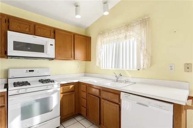 a kitchen with stainless steel appliances granite countertop a sink stove and microwave