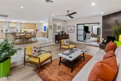 a living room with furniture kitchen view and a table