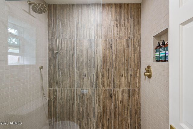 a bathroom with a shower curtain and a window