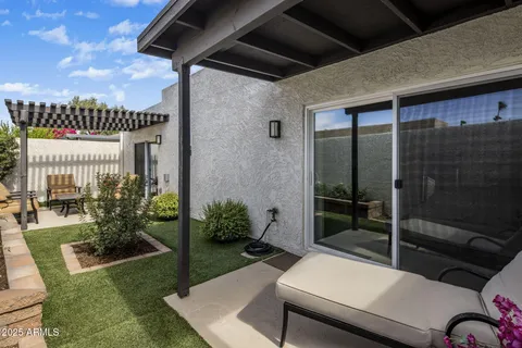 a view of a porch with furniture and a yard