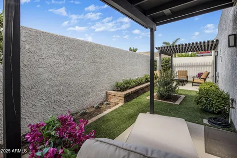 a view of a chair and table in the garden