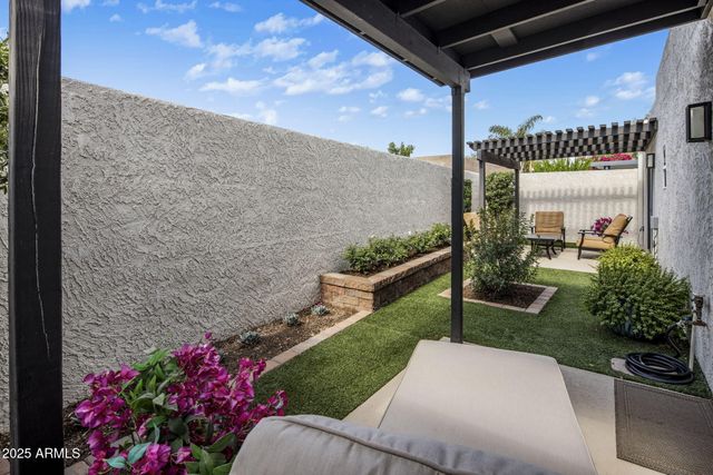 a view of a chair and table in the garden