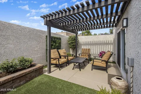 a patio with table and chairs