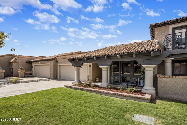 a view of a house with backyard porch and sitting area