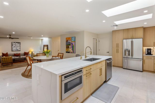 a kitchen with a sink appliances and cabinets