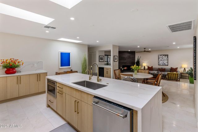 a kitchen with stainless steel appliances granite countertop a sink a counter top space and cabinets