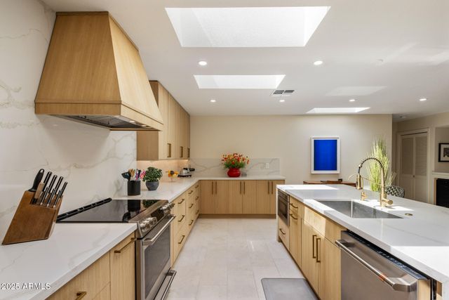 a kitchen with a sink and a stove top oven