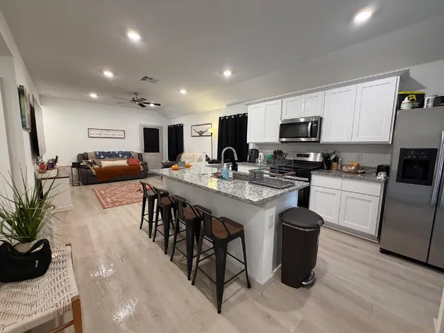 a kitchen with sink a microwave and refrigerator