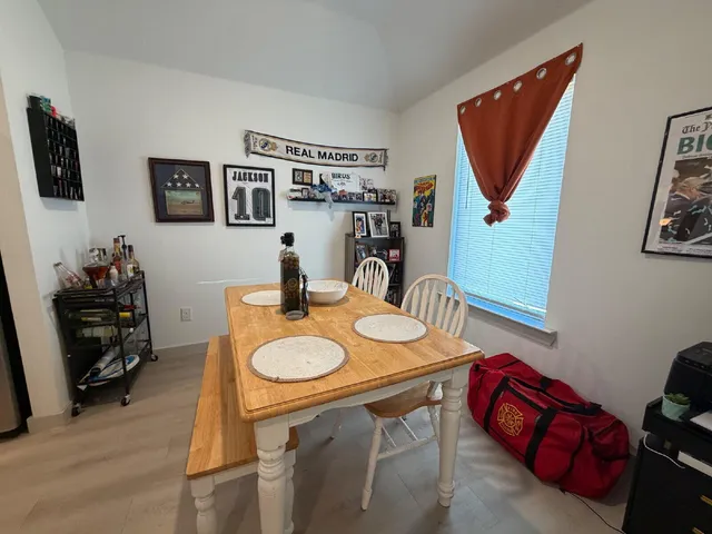 a dining room with furniture and a flat screen tv