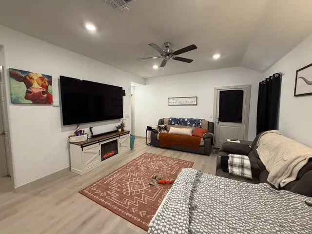 a living room with furniture and a flat screen tv