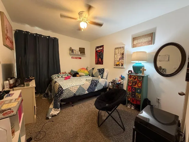 a bedroom with bed and a chandelier