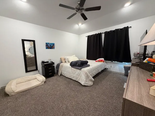 a bed room with furniture and a flat screen tv