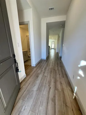 a bathroom with a double vanity sink a mirror and a bathtub