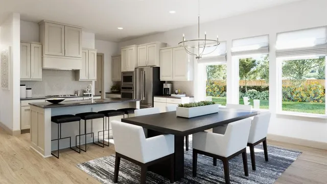 a kitchen with a dining table and chairs