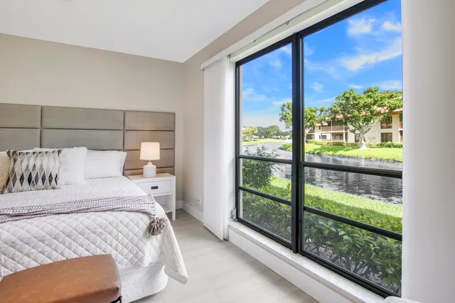 a bed sitting in a bedroom next to a large window