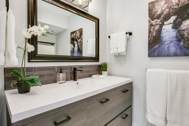 a bathroom with a sink a vanity and a mirror