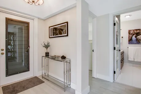 a view of a hallway with closet and a livingroom view