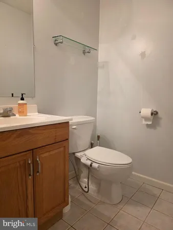 a bathroom with a sink a toilet and a mirror