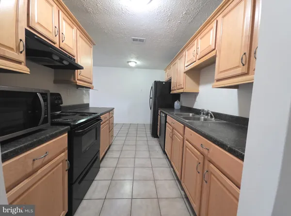 a kitchen with stainless steel appliances granite countertop a stove and a sink