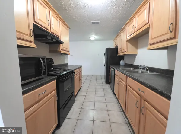 a kitchen that has a sink and a stove