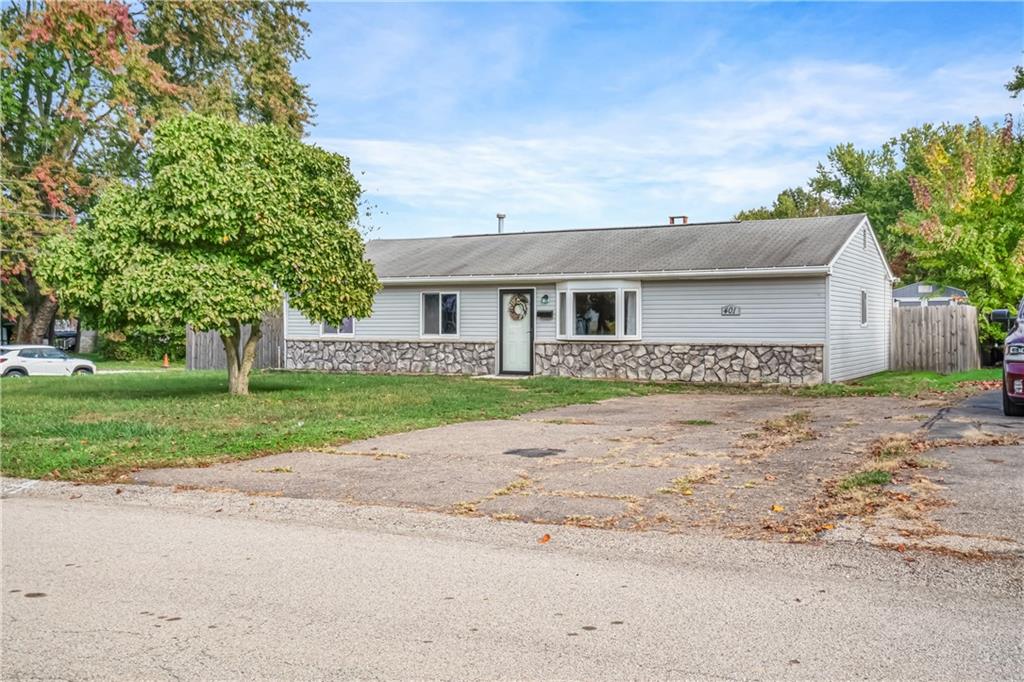 a front view of house with yard and green space