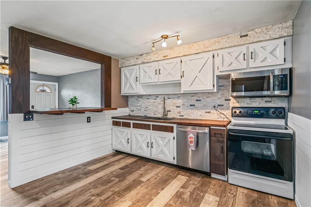 401 Rothey Drive Elizabeth, PA 15037 - Photo 4 of 17 a kitchen with stainless steel appliances granite countertop a stove microwave and cabinets