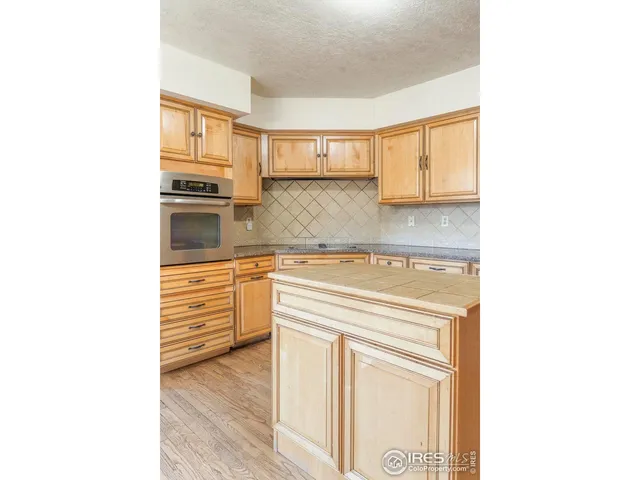 a kitchen with granite countertop a refrigerator and a stove