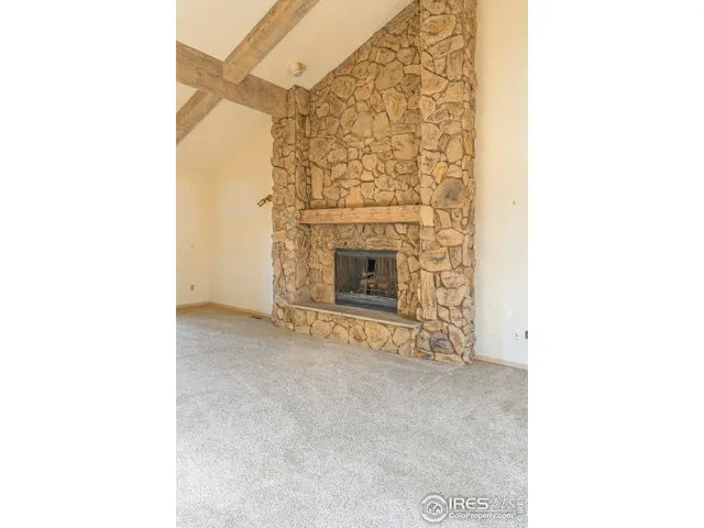 a view of an empty room with a fireplace