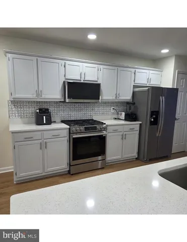a kitchen with a sink a stove and refrigerator