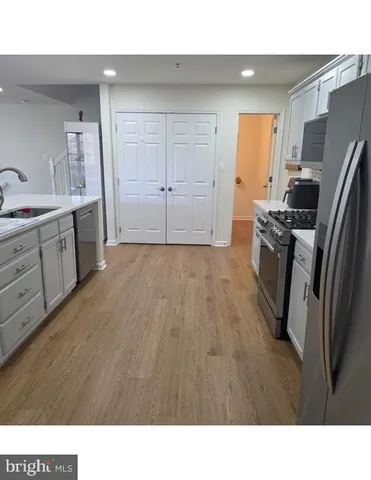 a open kitchen with a sink stainless steel appliances and cabinets