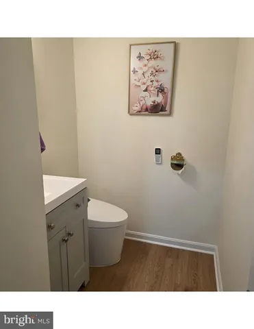 a bathroom with a sink a toilet and mirror