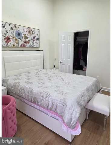 a bedroom with a bed and a painting on the wall