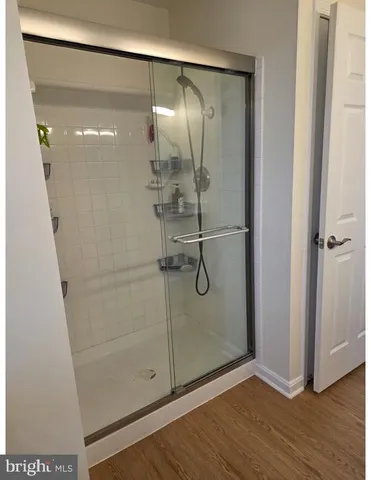a bathroom with a glass shower door