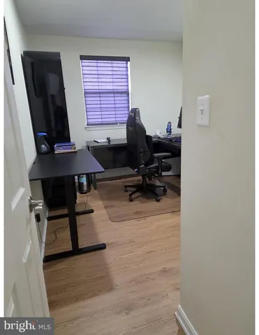 a view of a workspace with furniture and a window