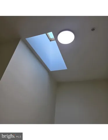 a living room with a bed and wall painting