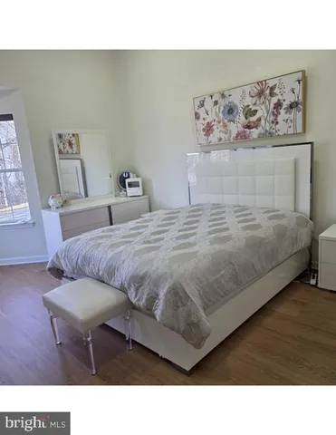 a room with a bed and mirror