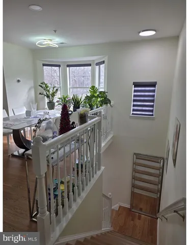 a view of an entryway wooden floor and table
