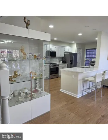 a kitchen with stainless steel appliances kitchen island granite countertop a sink and cabinets