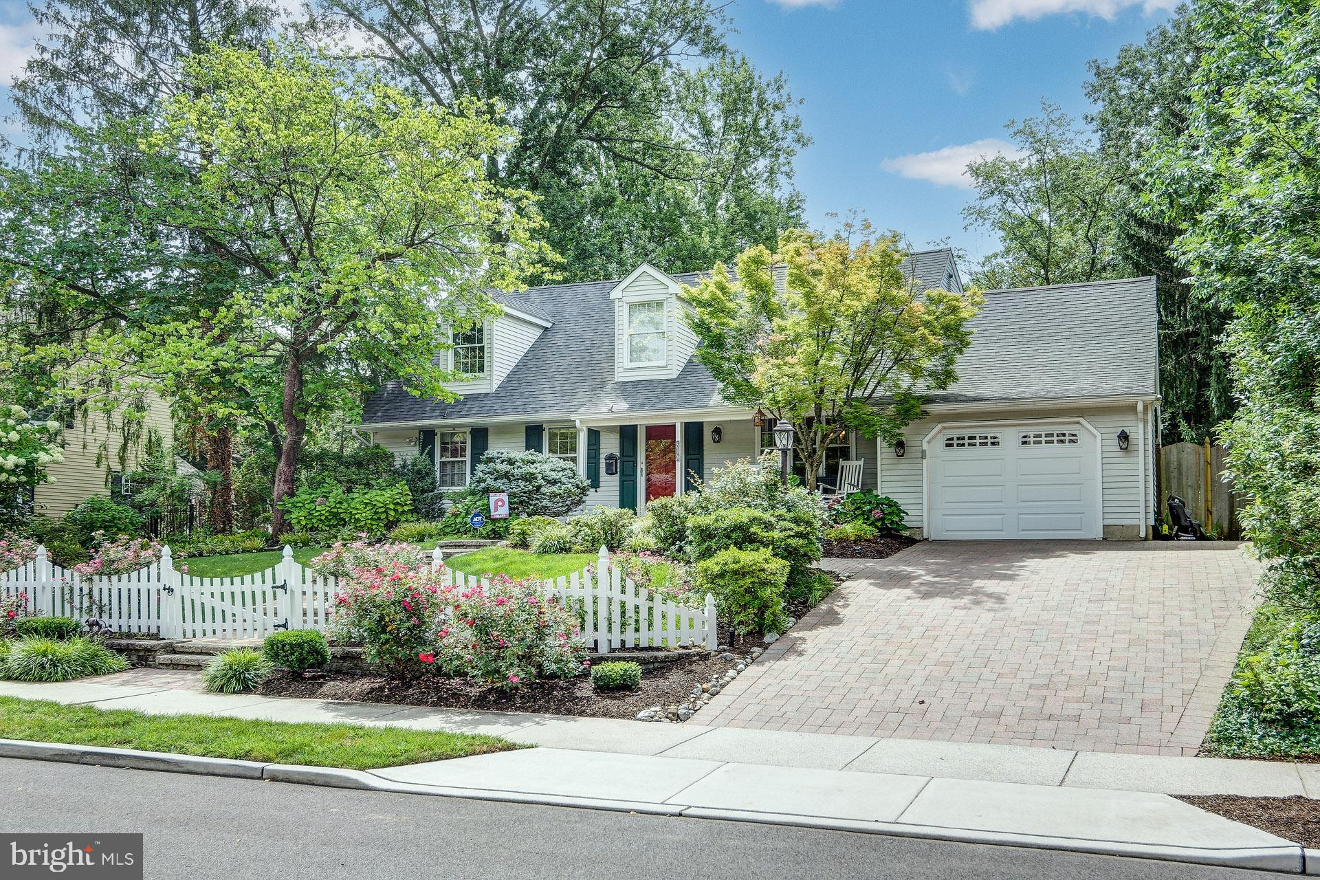 a front view of a house with a yard and potted plants