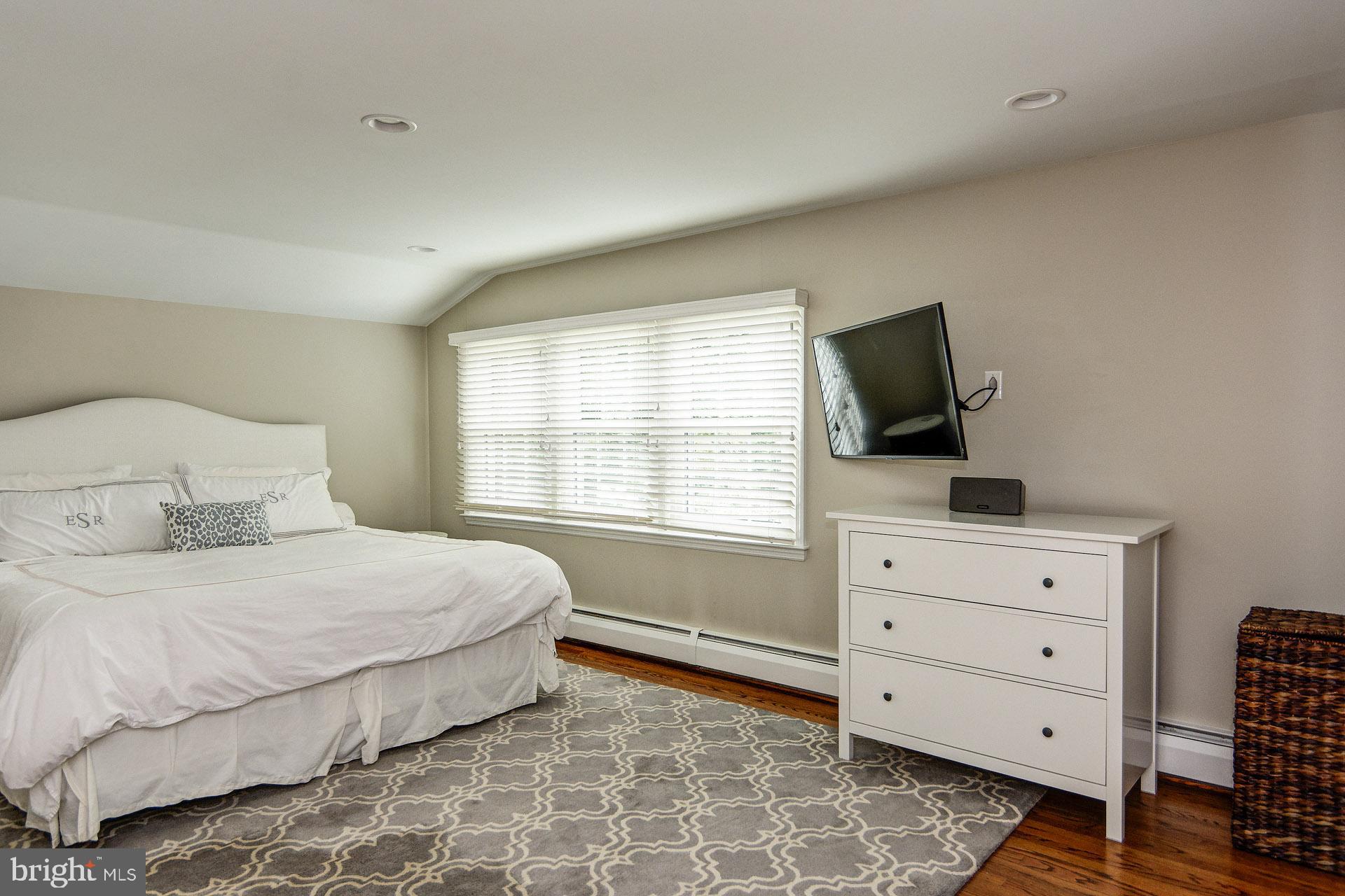 6 Heritage Road Haddonfield, NJ 08033 - Photo 51 of 61 a bedroom with a bed and flat tv screen on the dresser