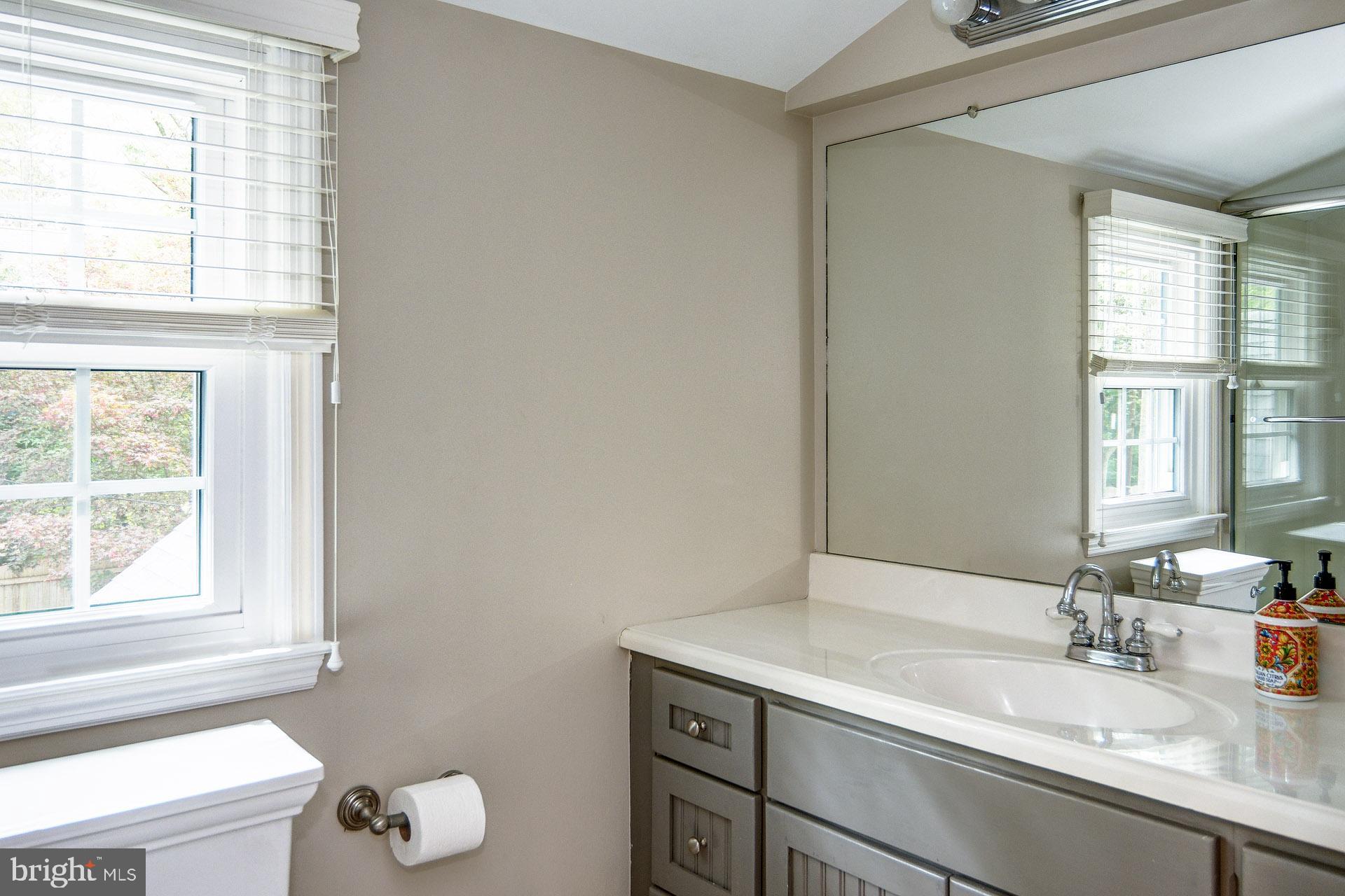 6 Heritage Road Haddonfield, NJ 08033 - Photo 61 of 61 a bathroom with a granite countertop sink a toilet and a window