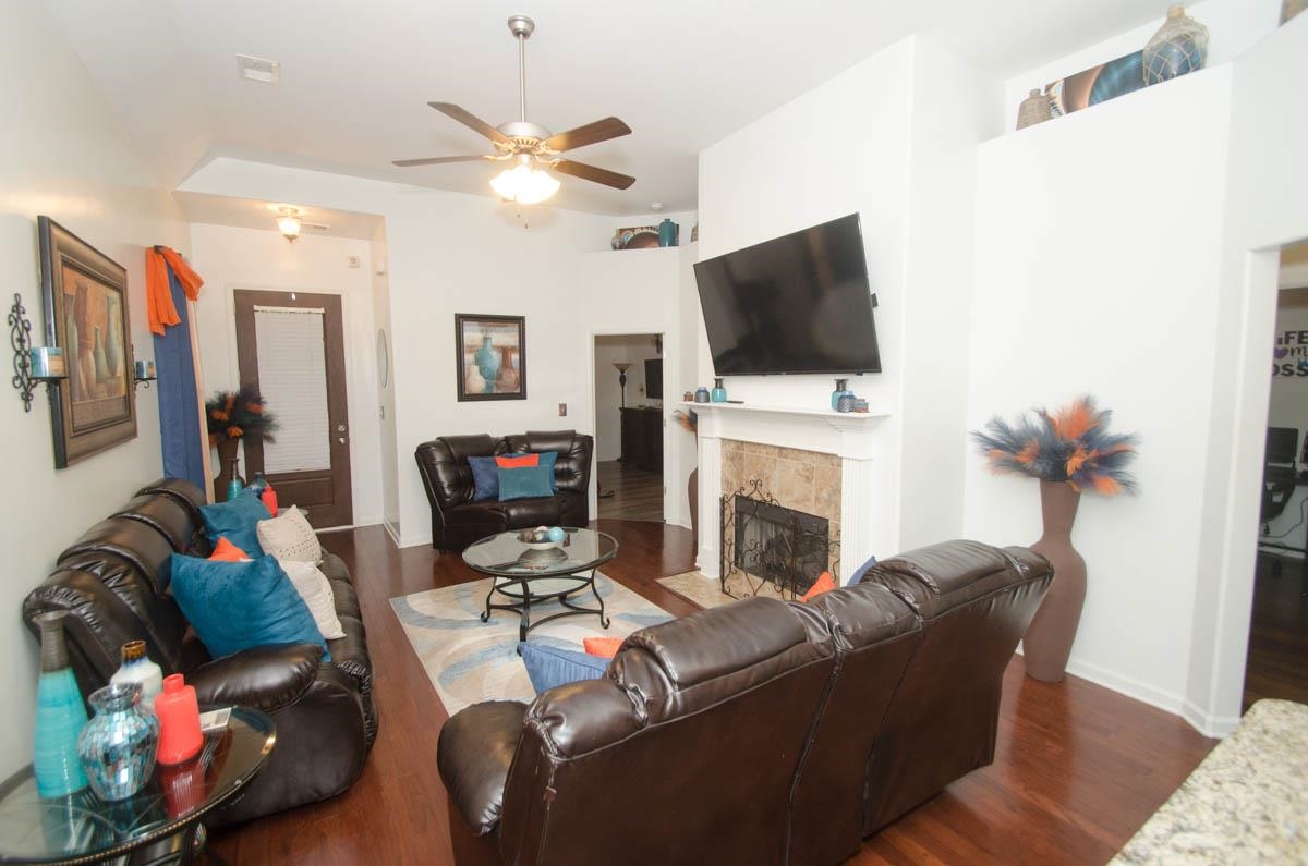 6905 Raleigh Lagrange Road Cordova, TN 38018 - Photo 4 of 17 a living room with furniture a fireplace and a flat screen tv