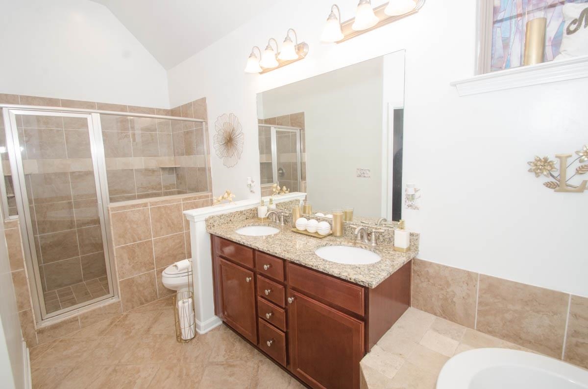 6905 Raleigh Lagrange Road Cordova, TN 38018 - Photo 8 of 17 a bathroom with a granite countertop sink toilet a mirror and shower