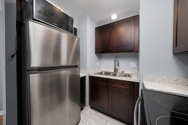 a kitchen with a refrigerator and a sink