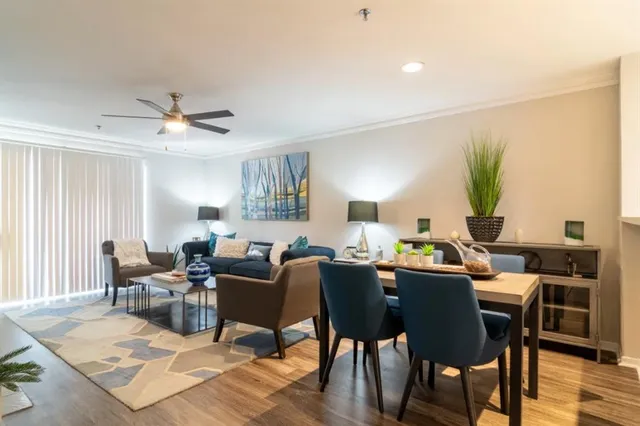 a living room with furniture a chandelier and a rug