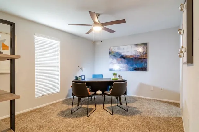 a dining room with furniture and window